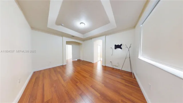 a view of a room with wooden floor and brick walls