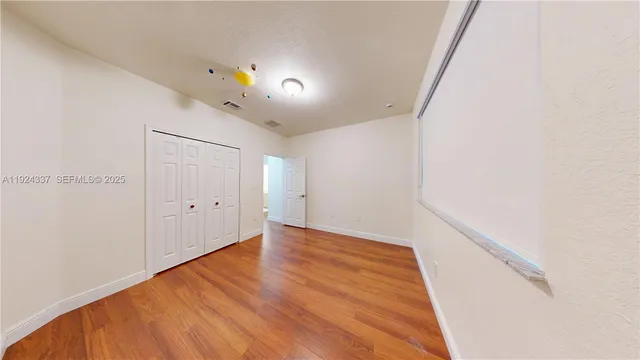 a view of a room with wooden floor