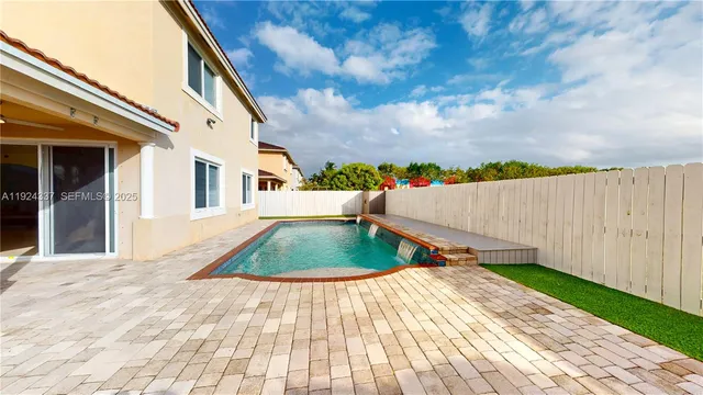a view of swimming pool with a backyard