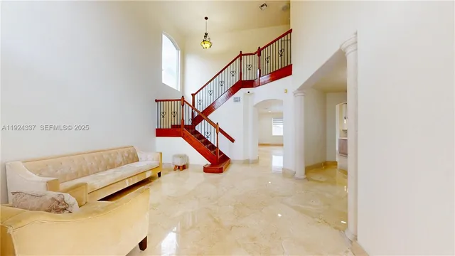 a living room with furniture and stairs