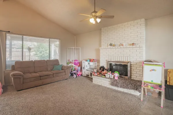 a kitchen with a dining table chairs and refrigerator