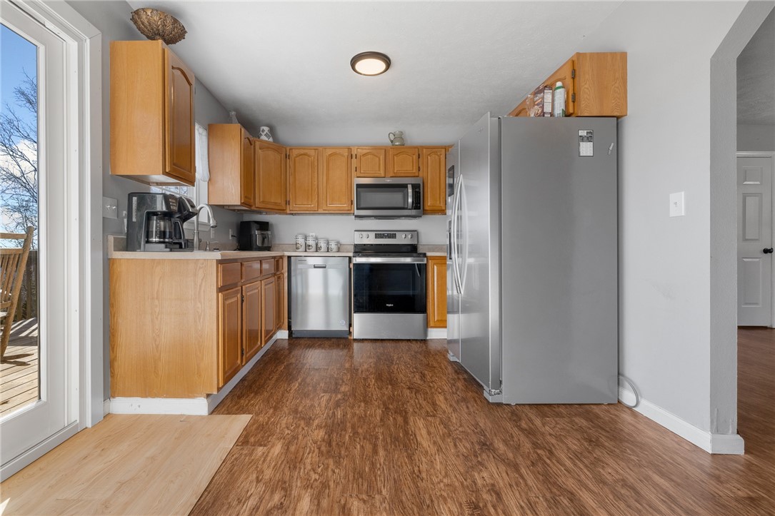 10974 Ricks Drive Harrison, AR 72601 - Photo 21 of 59 Kitchen with stainless steel appliances, light countertops, and dark wood-style floors