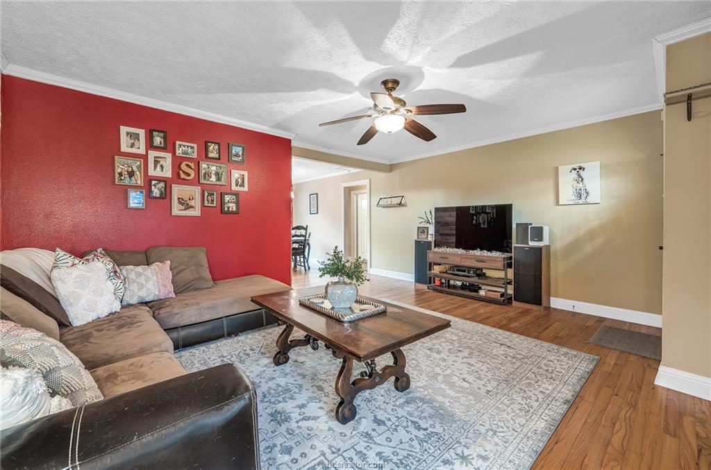 1414 East 29th Street Bryan, TX 77802 - Photo 5 of 21 a living room with furniture a rug and a flat screen tv