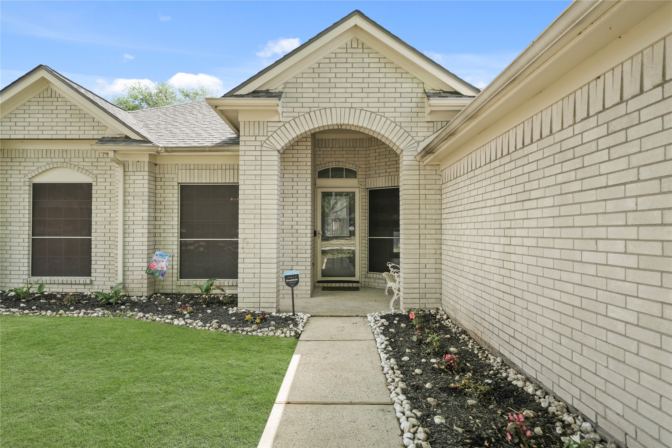 8134 Blue Jay Street Baytown, TX 77523 - Photo 4 of 31 Striking white brick exterior enhances the home’s curb appeal, offering a refined and inviting presence that is sure to impress both residents and guests alike.