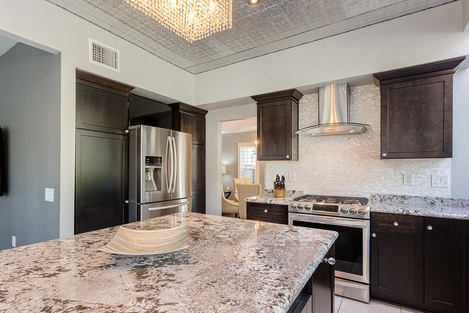 15317 Rains Court Moorpark, CA 93021 - Photo 13 of 34 a kitchen with stainless steel appliances granite countertop a sink stove and refrigerator
