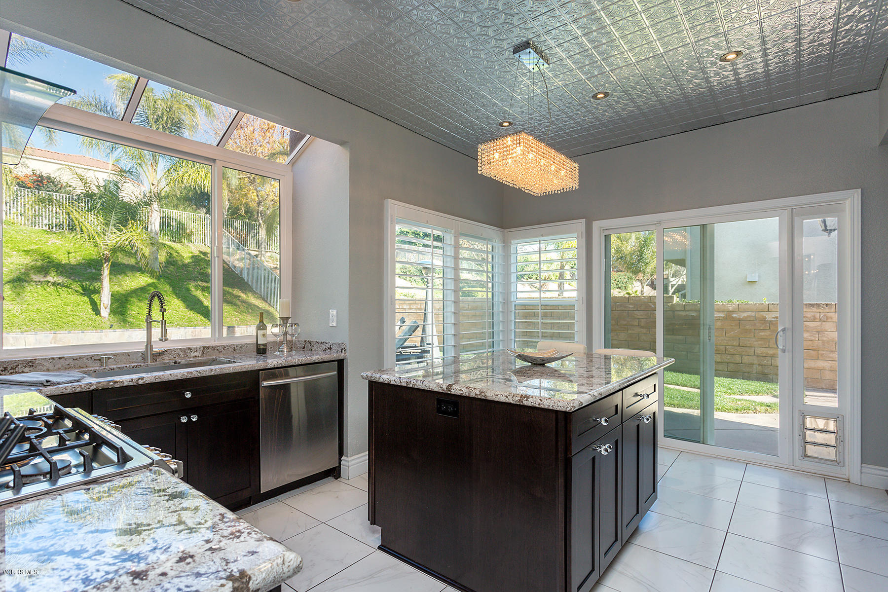 15317 Rains Court Moorpark, CA 93021 - Photo 14 of 34 a kitchen with granite countertop a sink and a stove