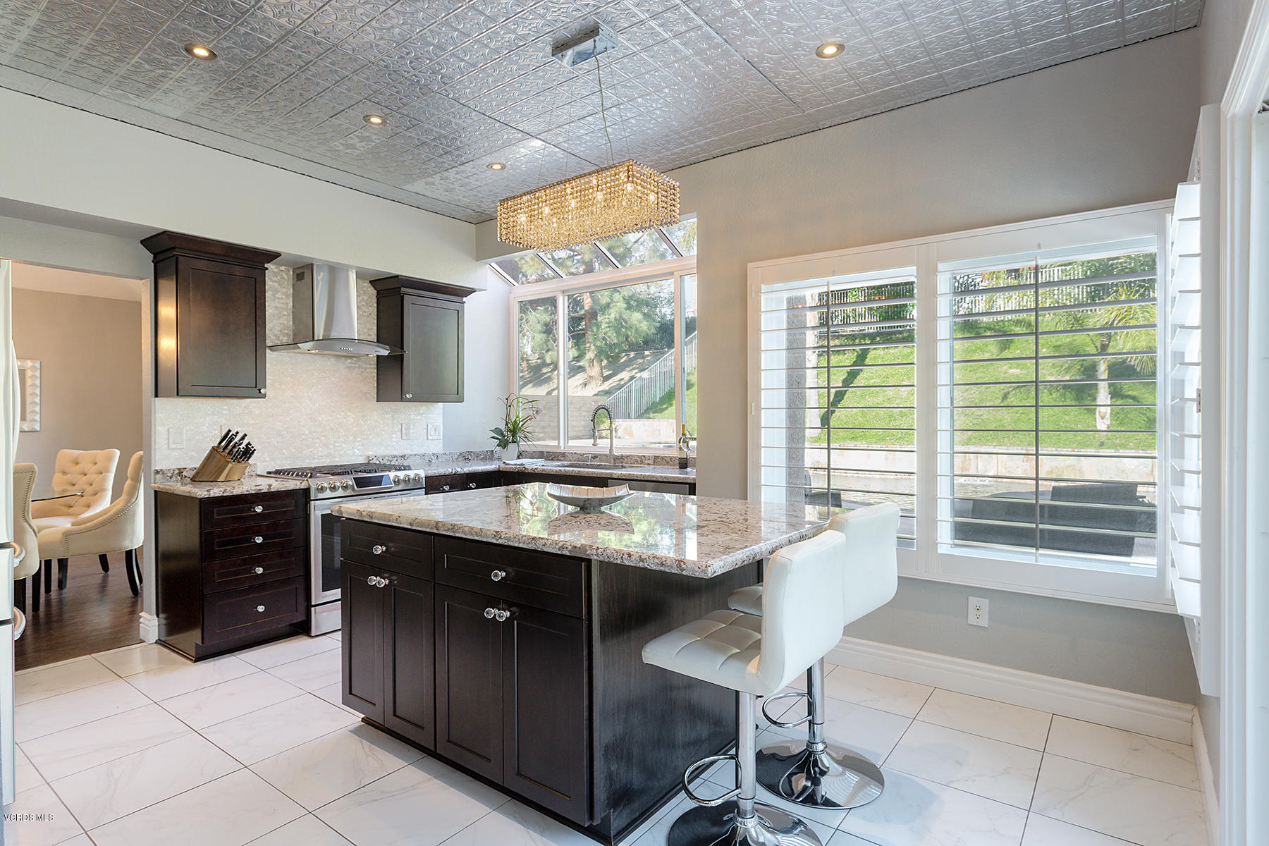 15317 Rains Court Moorpark, CA 93021 - Photo 10 of 34 a kitchen with stainless steel appliances granite countertop a sink counter space cabinets and a dining table