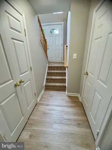 a view of a hallway view with wooden floor and staircase