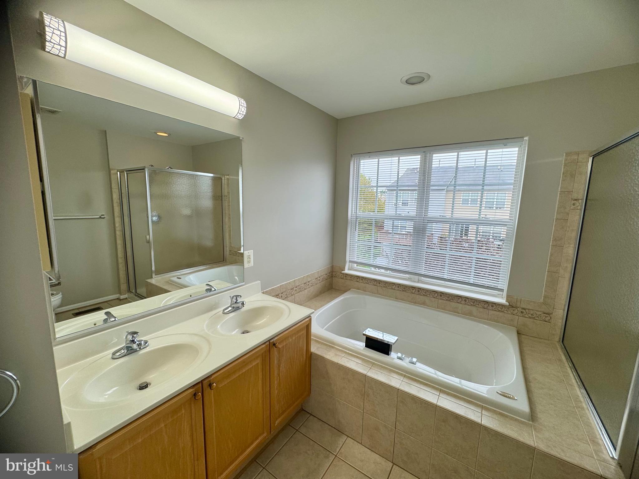 1945 Fieldstone Way Frederick, MD 21702 - Photo 19 of 25 a bathroom with a tub sink and mirror