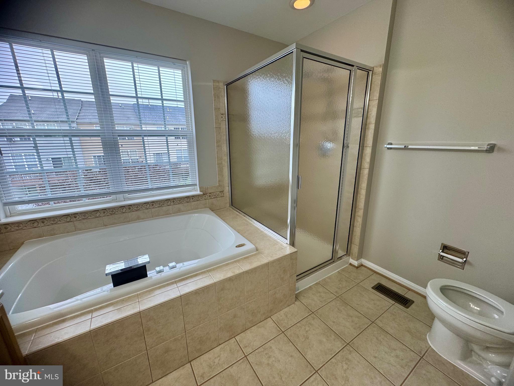 1945 Fieldstone Way Frederick, MD 21702 - Photo 20 of 25 a bathroom with a tub and a shower