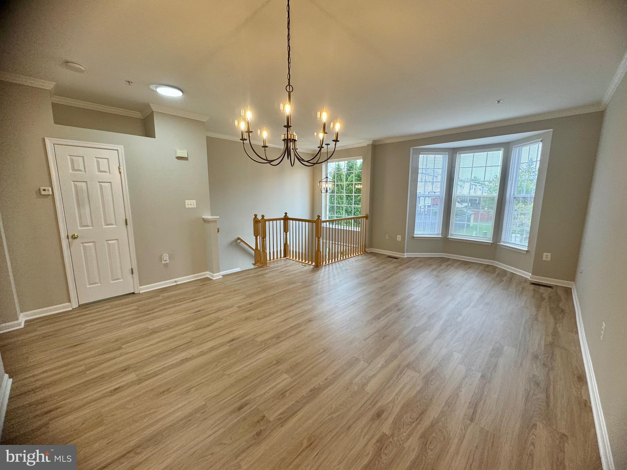1945 Fieldstone Way Frederick, MD 21702 - Photo 2 of 25 a view of an empty room with wooden floor and a window