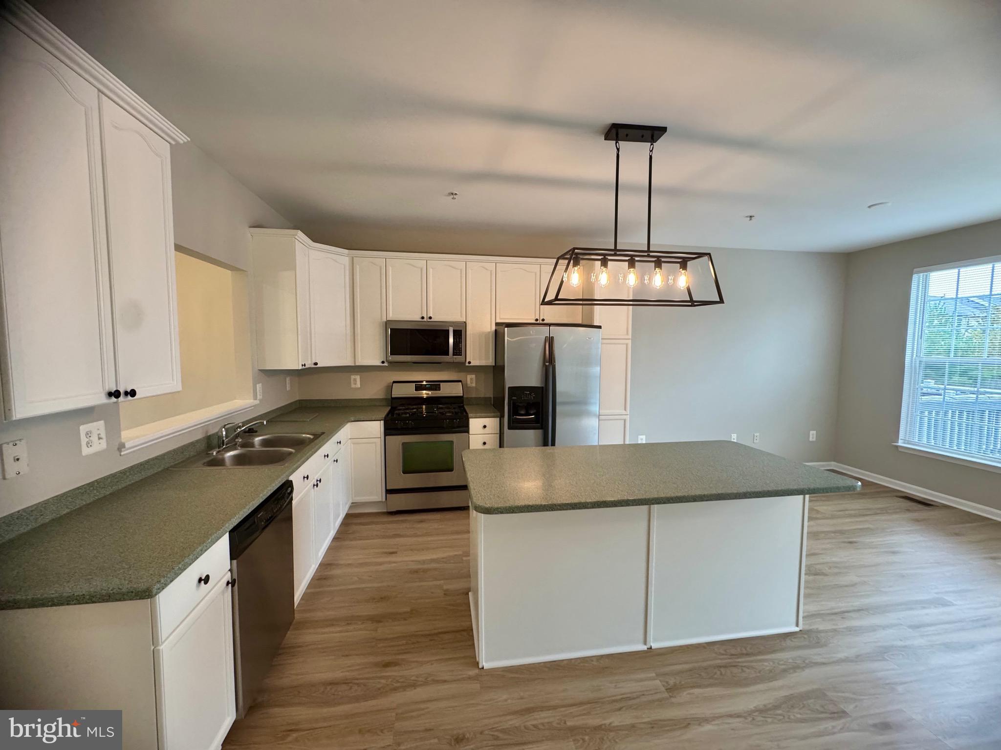 1945 Fieldstone Way Frederick, MD 21702 - Photo 5 of 25 a kitchen with stainless steel appliances granite countertop a sink stove and refrigerator