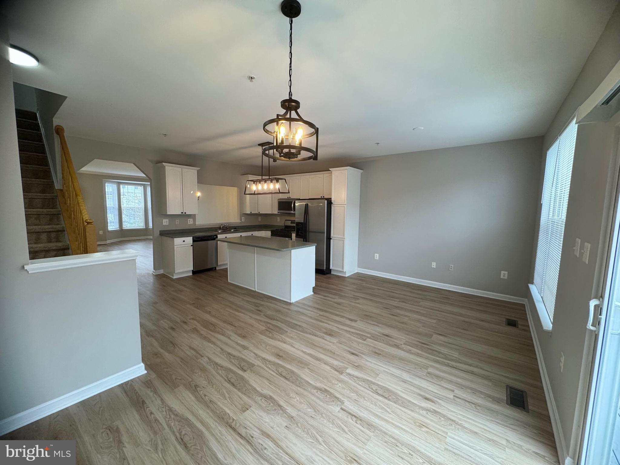 1945 Fieldstone Way Frederick, MD 21702 - Photo 7 of 25 a view of a kitchen with stove and wooden floor