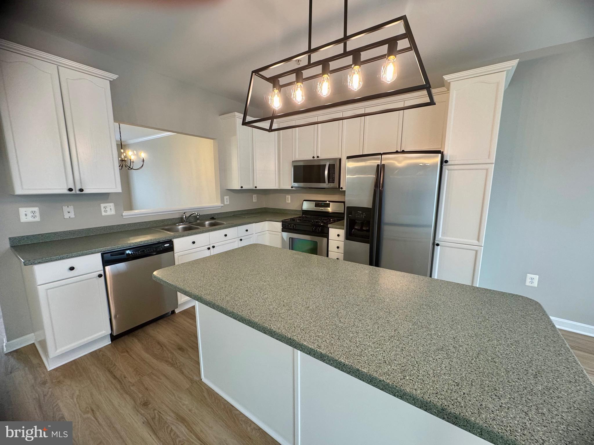 1945 Fieldstone Way Frederick, MD 21702 - Photo 9 of 25 a kitchen with stainless steel appliances granite countertop a sink dishwasher a refrigerator and a stove with wooden floor
