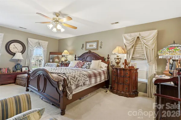 a bedroom with a bed and ceiling fan