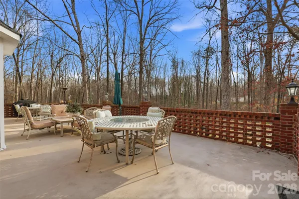 a view of a patio with table and chairs and potted plants