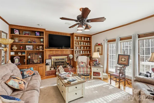 a living room with fireplace furniture and a flat screen tv