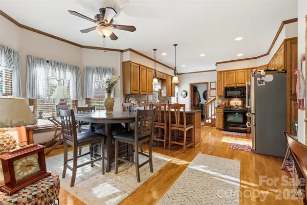 a living room with lots of furniture and a view of kitchen