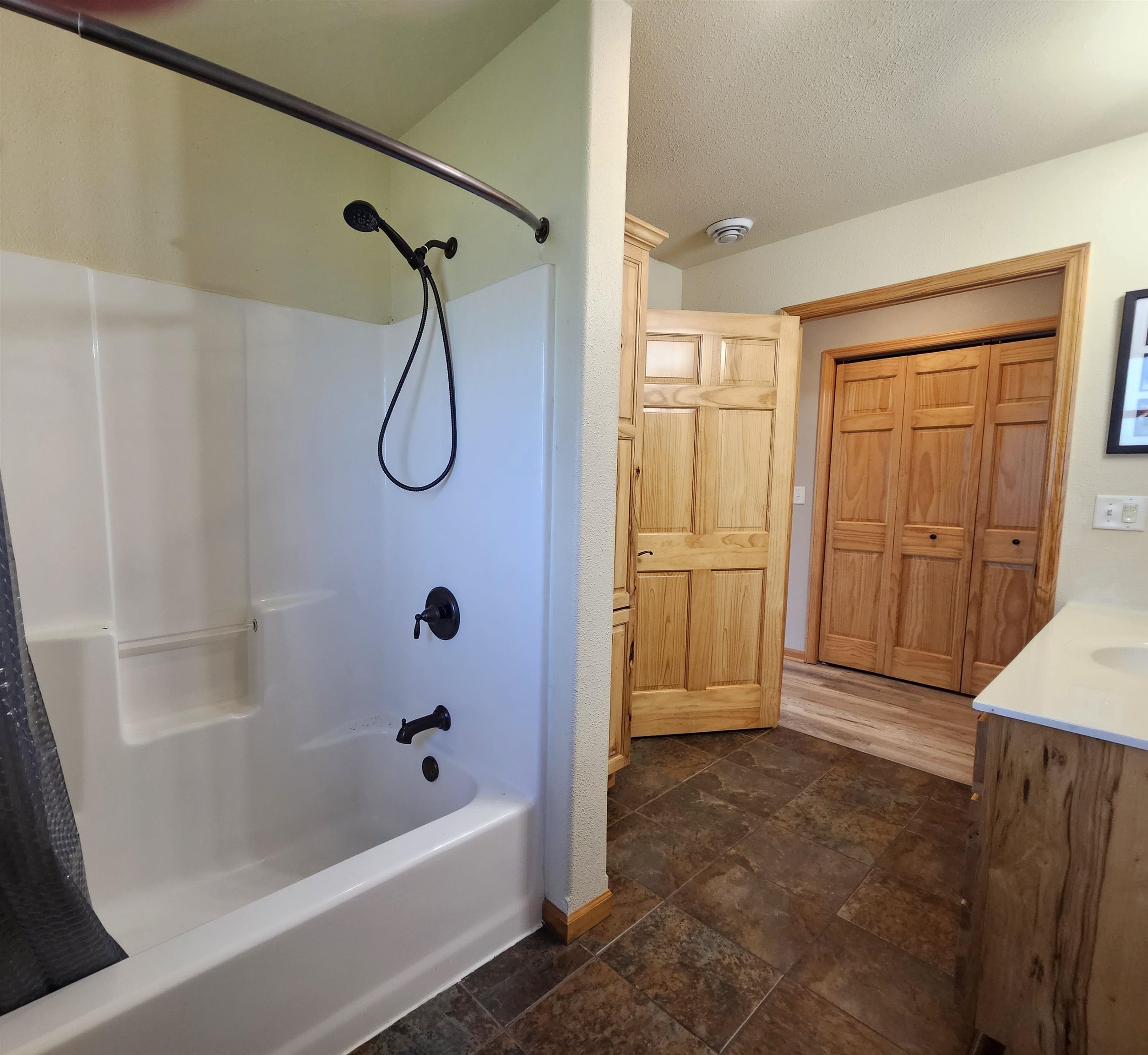 13179 County Rd FF Maple, WI 54854 - Photo 12 of 29 Bathroom featuring shower / tub combo with curtain, vanity, a textured ceiling