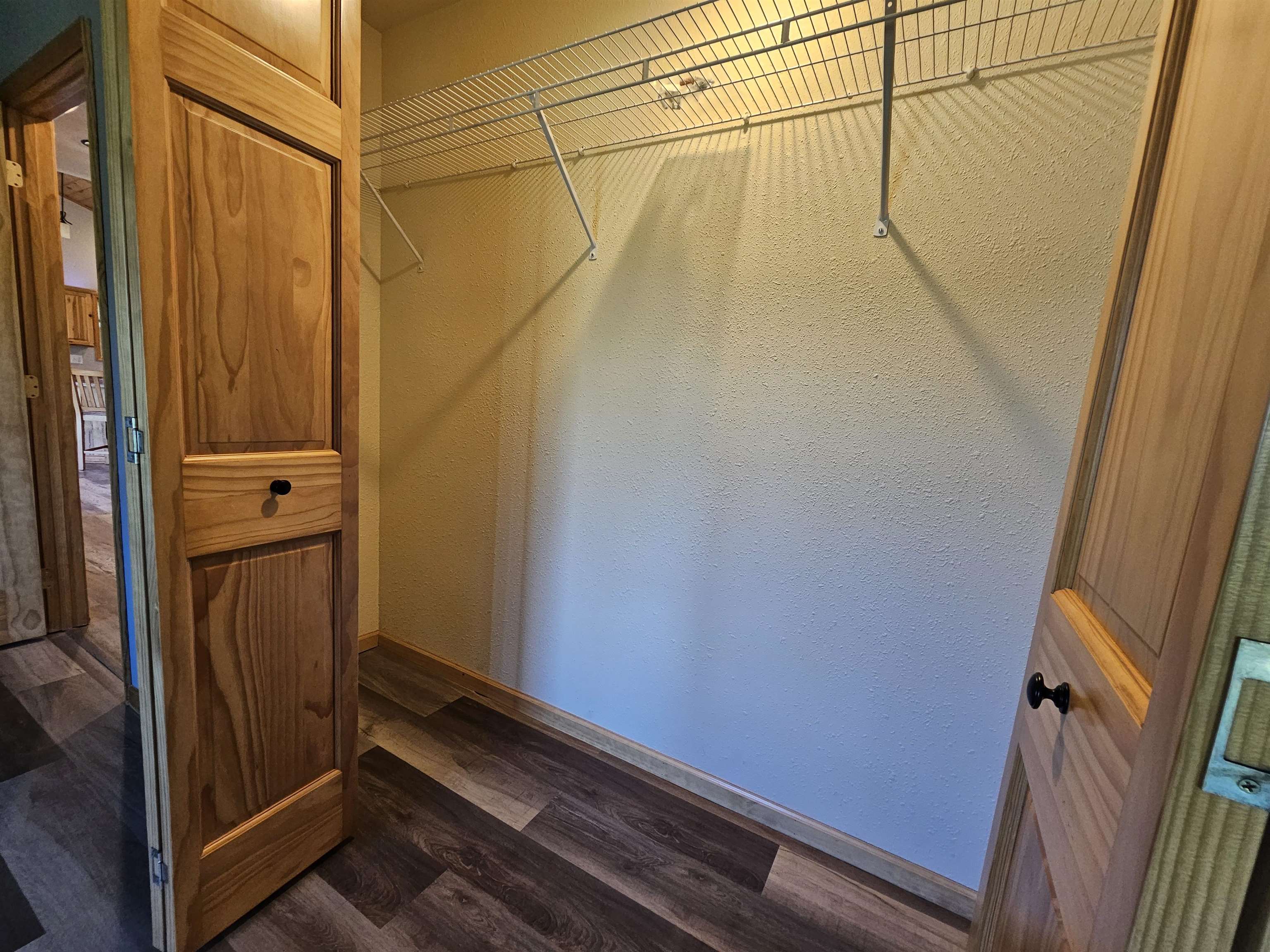 13179 County Rd FF Maple, WI 54854 - Photo 14 of 29 Spacious closet with dark wood-style floors