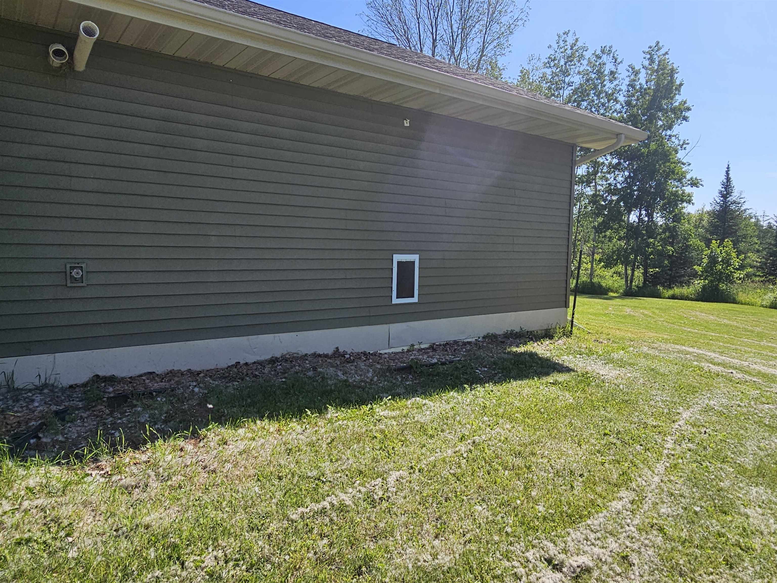 13179 County Rd FF Maple, WI 54854 - Photo 27 of 29 View of side of garage with pet door