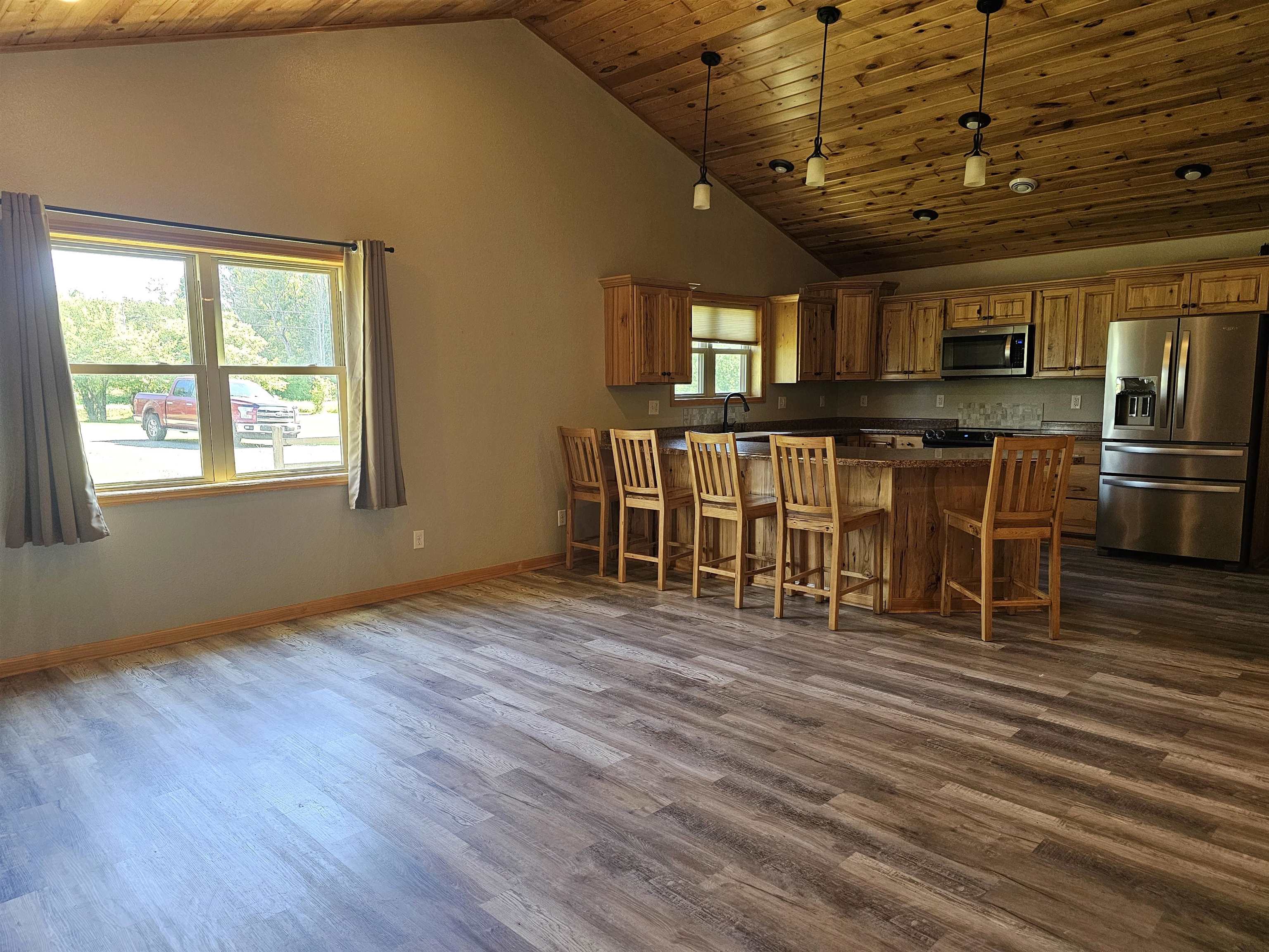 13179 County Rd FF Maple, WI 54854 - Photo 3 of 29 Kitchen with appliances with stainless steel finishes, high vaulted ceiling, wood ceiling, dark wood-type flooring, and dark countertops