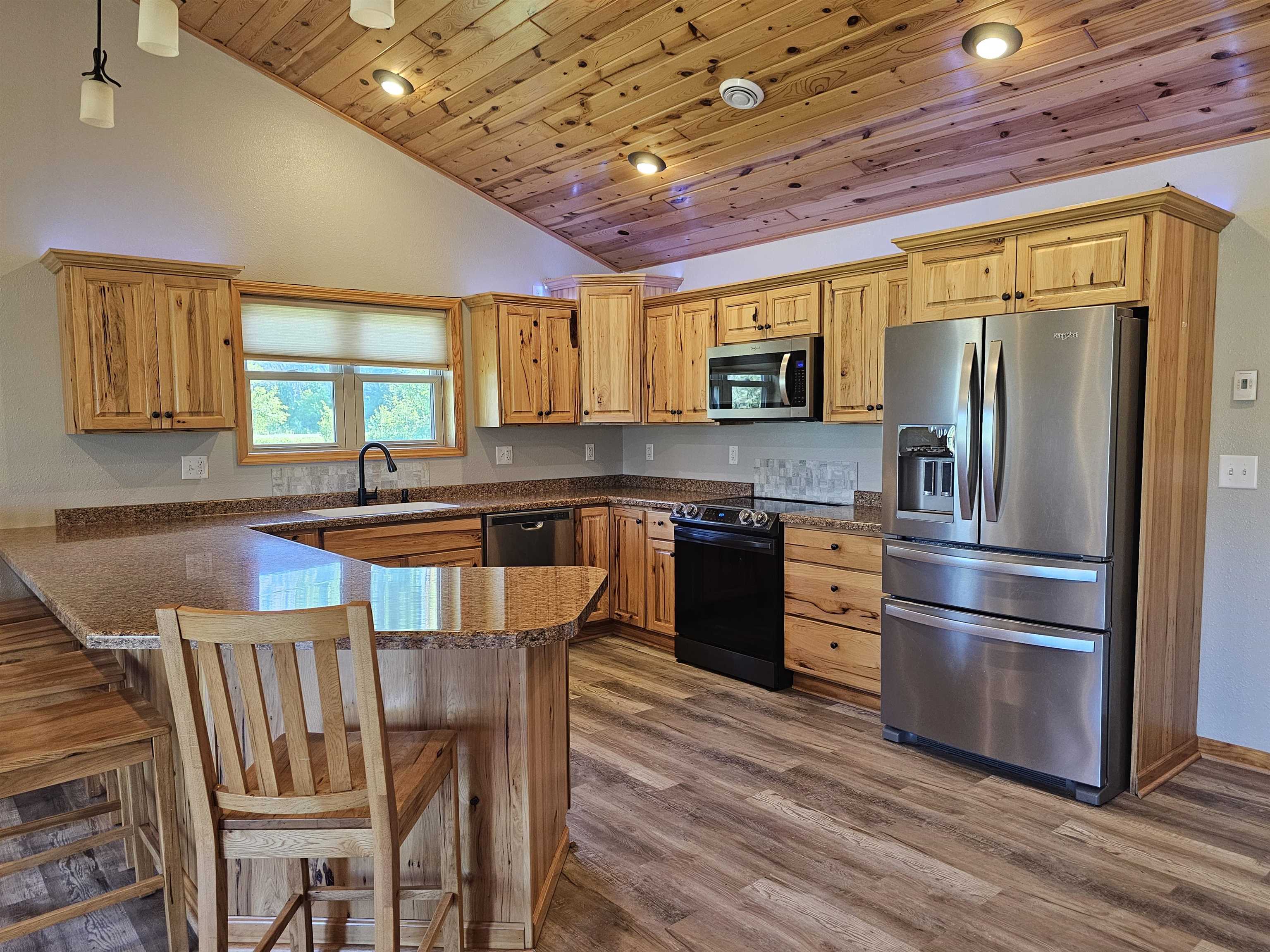 13179 County Rd FF Maple, WI 54854 - Photo 4 of 29 Kitchen featuring appliances with stainless steel finishes, vaulted ceiling, wood ceiling, a peninsula