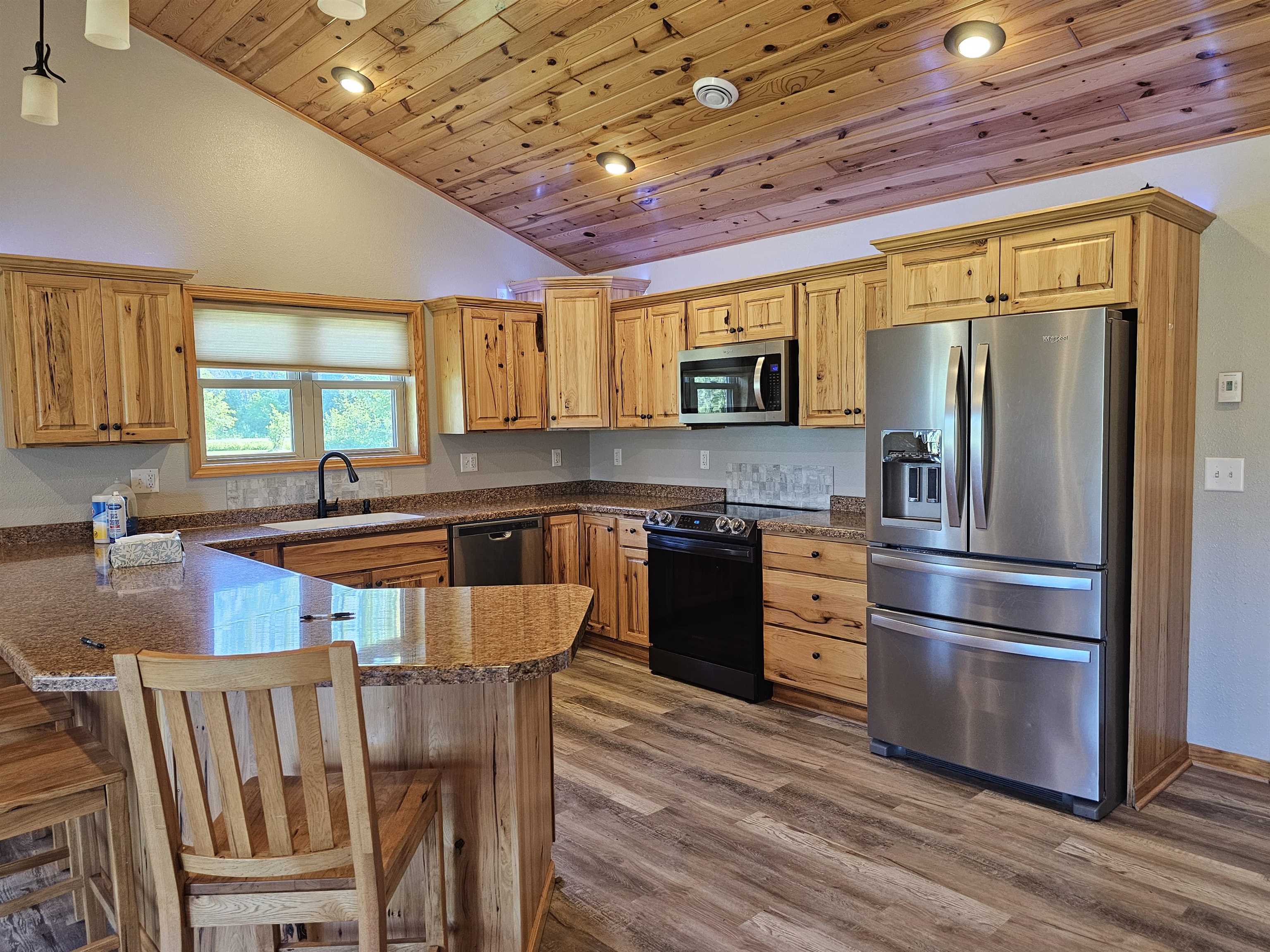 13179 County Rd FF Maple, WI 54854 - Photo 5 of 29 Kitchen featuring stainless steel appliances, vaulted ceiling, wooden ceiling, a peninsula