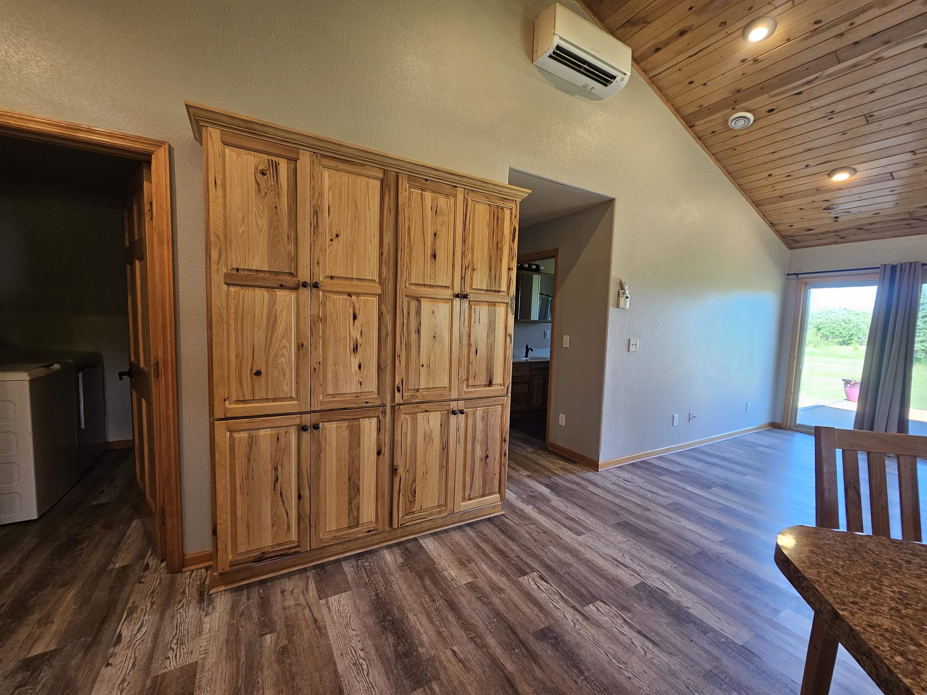 13179 County Rd FF Maple, WI 54854 - Photo 6 of 29 Kitchen featuring an AC wall unit, wooden ceiling, brown cabinetry, and high vaulted ceiling