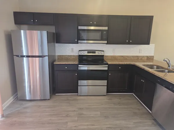 a kitchen with a refrigerator sink and microwave