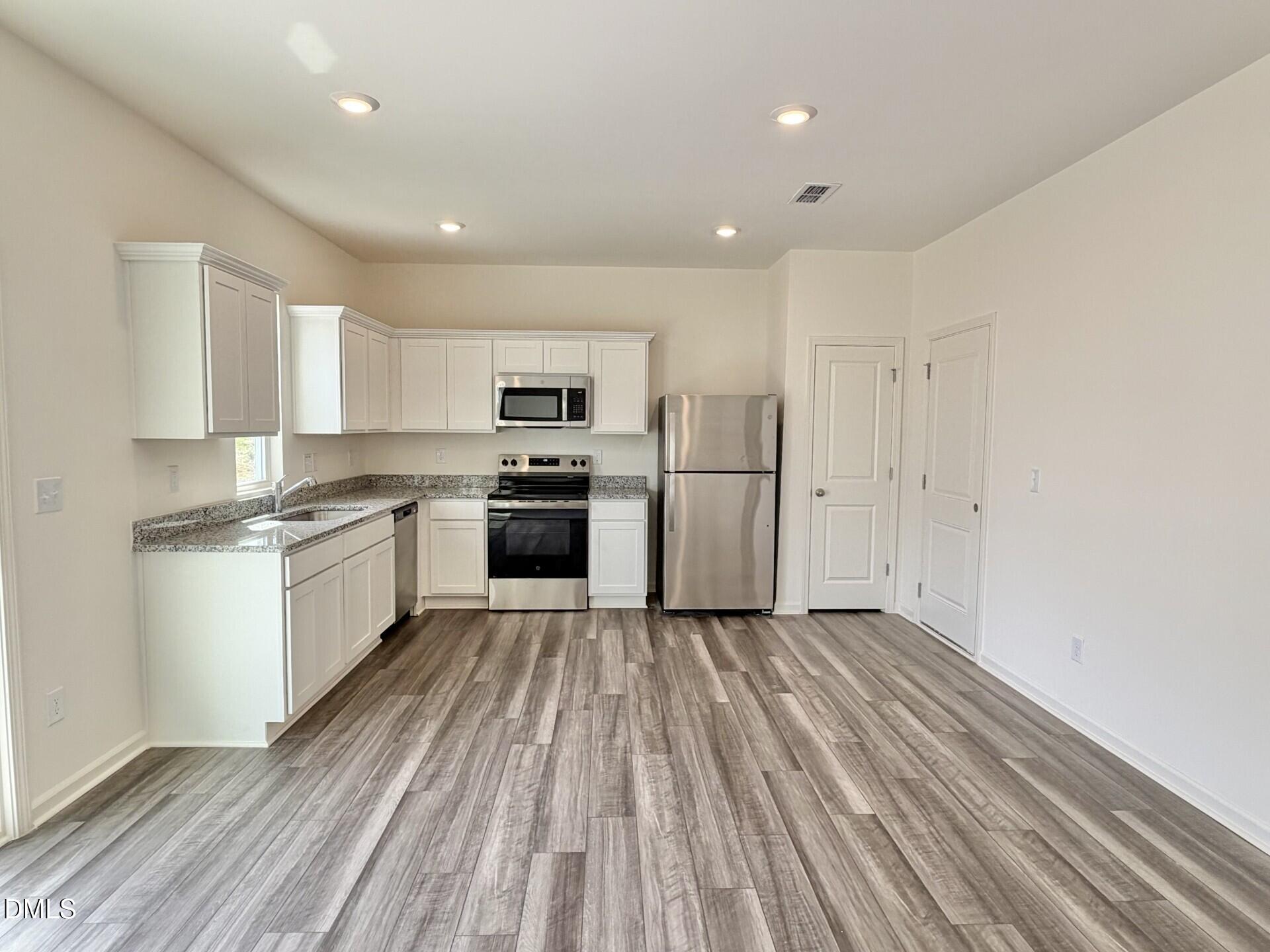 1010 Bombardier Alley Spring Hope, NC 27882 - Photo 11 of 30 a kitchen with stove cabinets and refrigerator