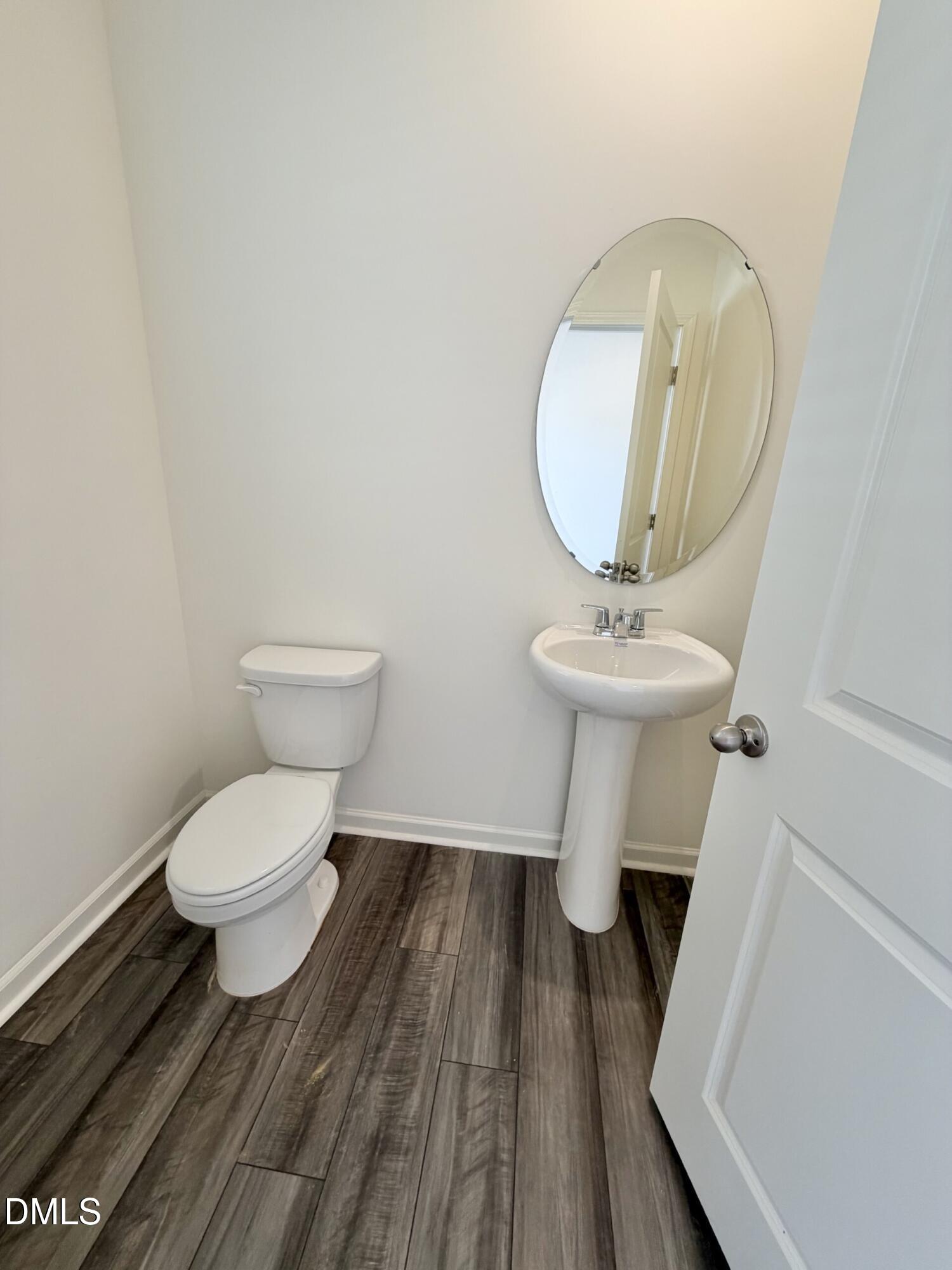 1010 Bombardier Alley Spring Hope, NC 27882 - Photo 13 of 30 a bathroom with a toilet a sink and a mirror