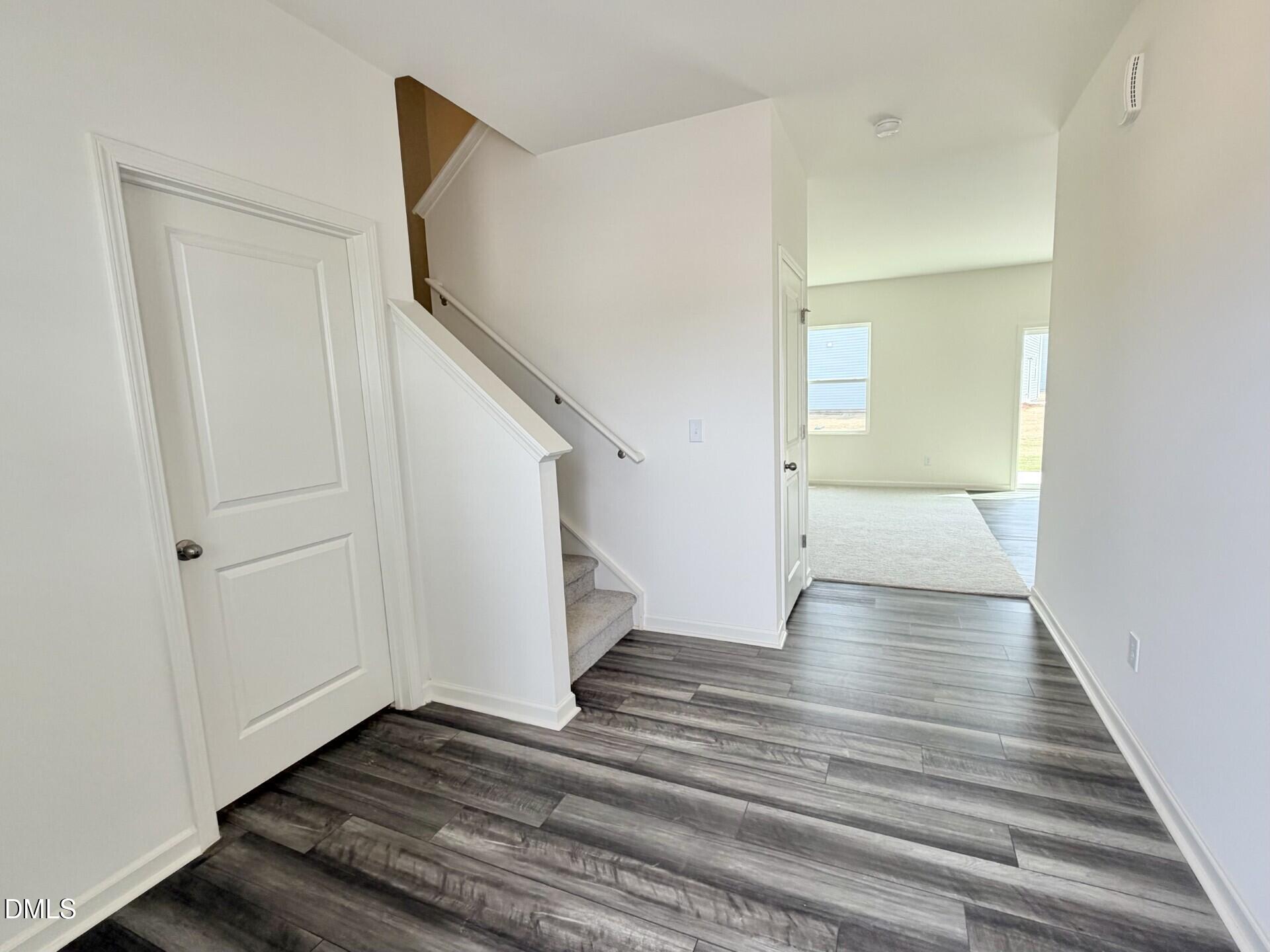 1010 Bombardier Alley Spring Hope, NC 27882 - Photo 5 of 30 a view of an empty room with wooden floor and stairs