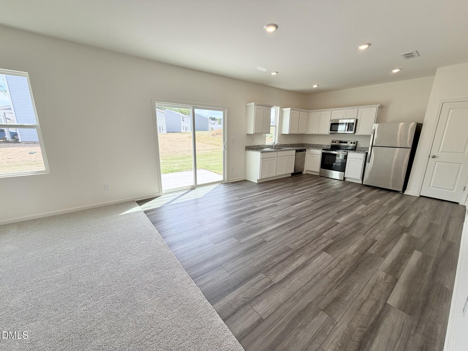 1010 Bombardier Alley Spring Hope, NC 27882 - Photo 7 of 30 a view of a kitchen with wooden floor and electronic appliances