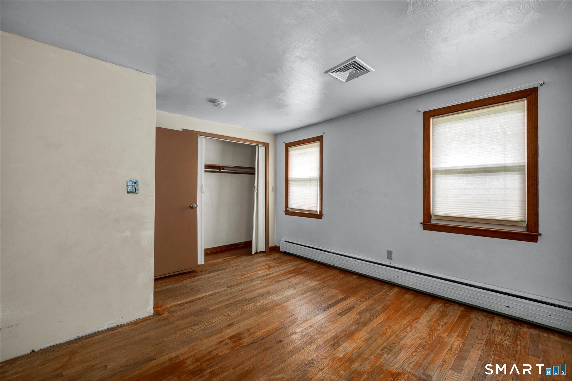 740 Rainbow Road Windsor, CT 06095 - Photo 25 of 40 a view of an empty room with wooden floor and a window