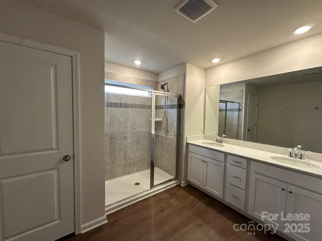 a bathroom with a shower sink and mirror