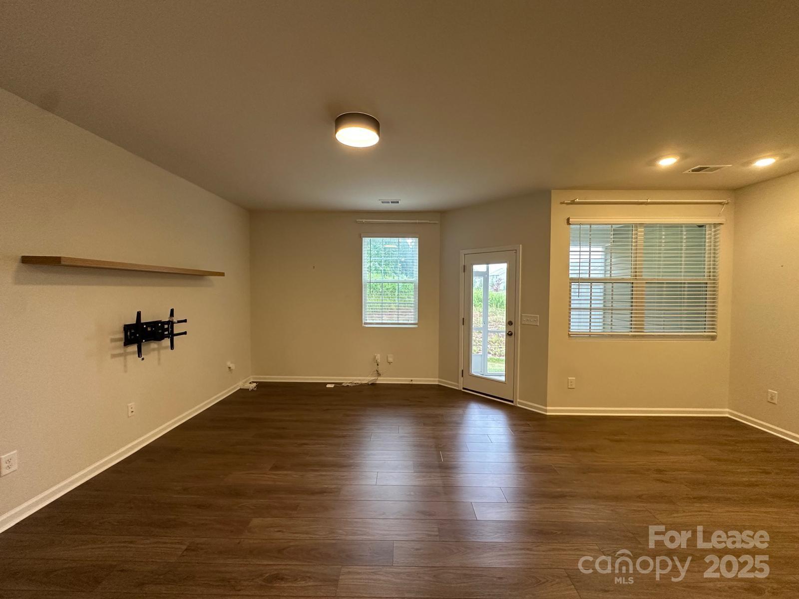 14140 Castle Nook Drive Charlotte, NC 28273 - Photo 2 of 17 an empty room with wooden floor and windows