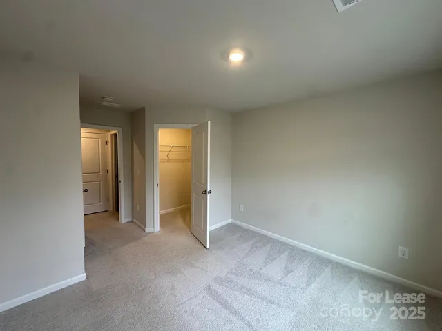 an empty room with closet and a bathroom
