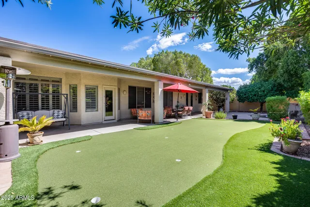 a view of an house with swimming pool patio and garden
