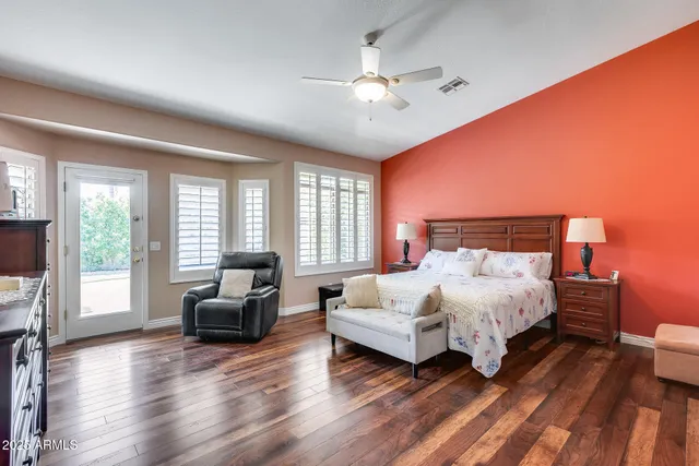 a view of a hallway with wooden floor windows and a livingroom
