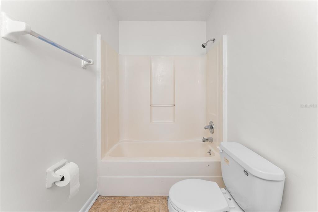 2026 Southwest 73rd Street Gainesville, FL 32607 - Photo 11 of 20 a bathroom with a toilet and a bathtub