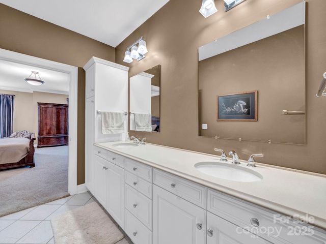 a spacious bathroom with a double vanity sink and a mirror