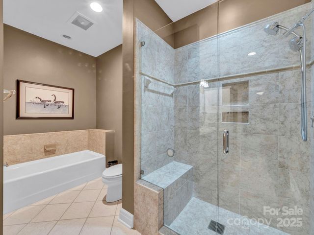 a bathroom with a shower a bath tub and a shower