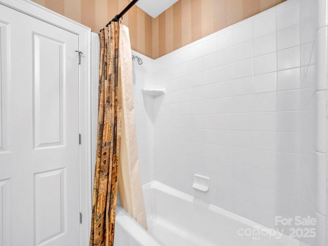 a bathroom with a bathtub and shower