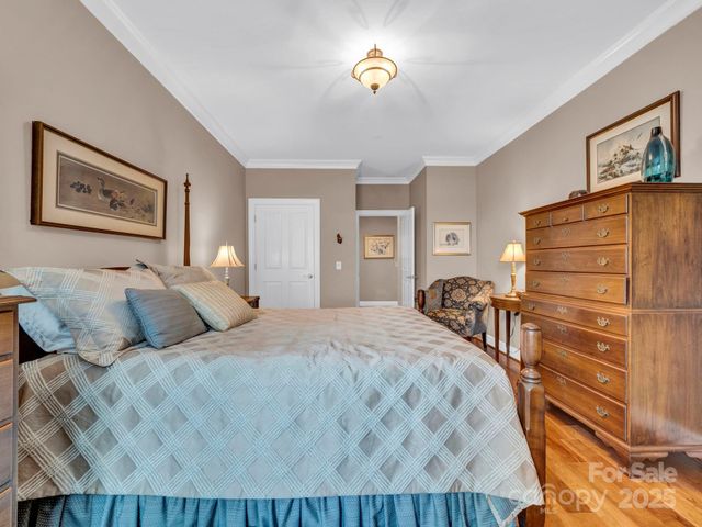 a bedroom with a bed and a view of kitchen