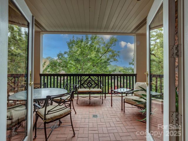 a balcony with furniture and a gate