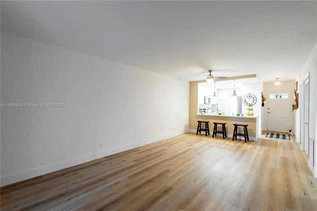 a view of a room with wooden floor and furniture