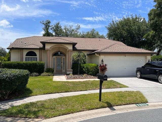 7825 Bengal New Port New Port Richey, FL 34654 - Photo 1 of 39 a front view of a house with garden