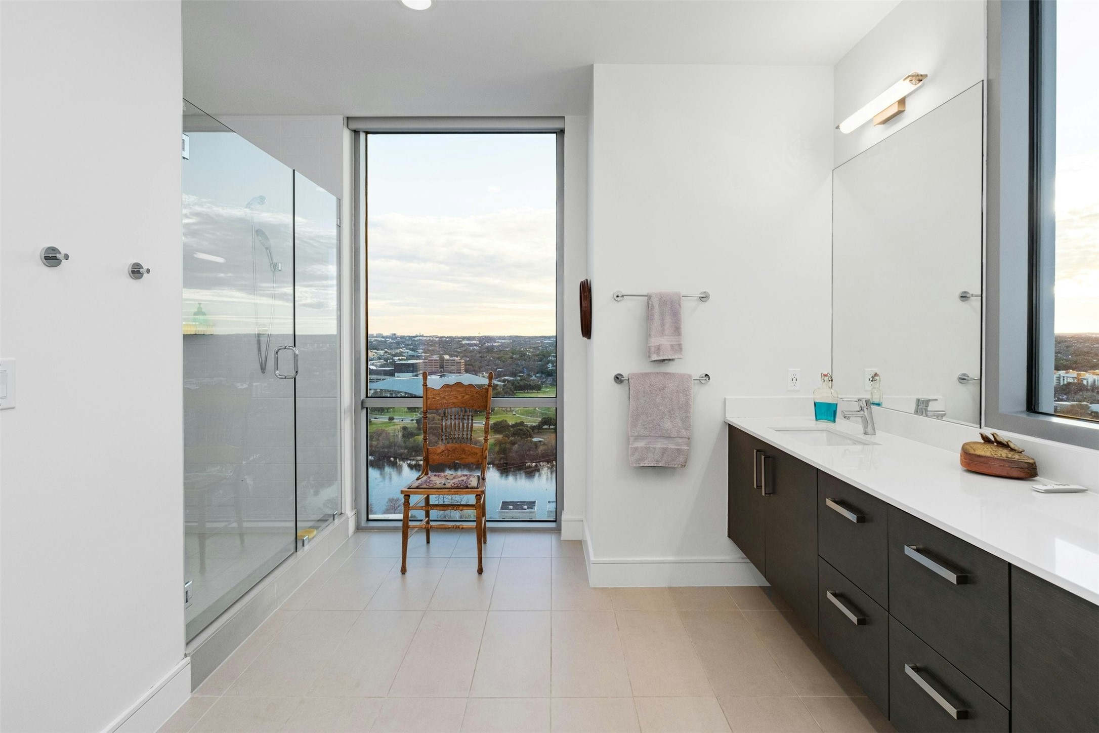 222 West Avenue, Unit 2201 Austin, TX 78701 - Photo 14 of 37 a spacious bathroom with a double vanity sink a mirror and a shower