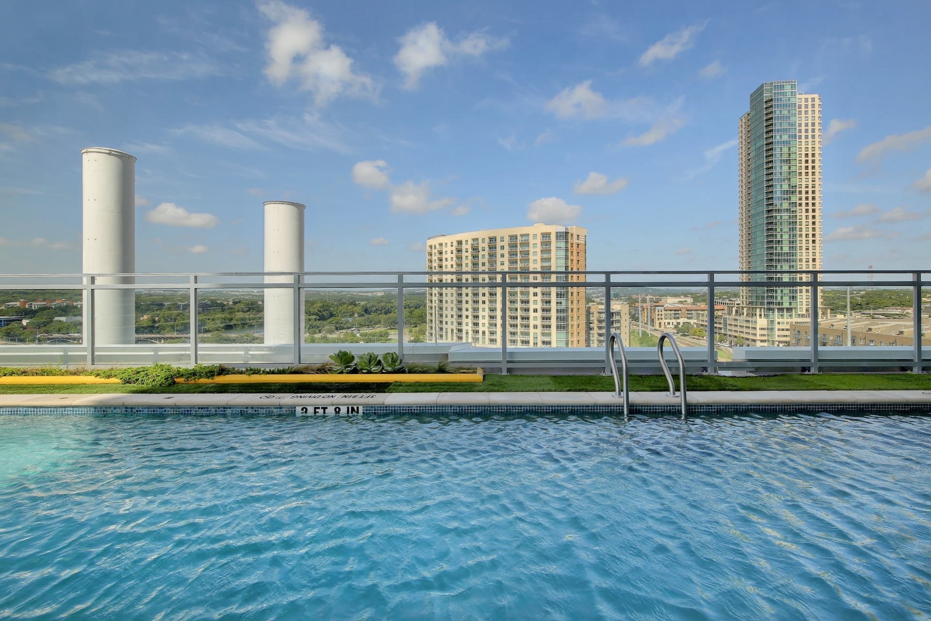 222 West Avenue, Unit 2201 Austin, TX 78701 - Photo 33 of 37 a view of pool with a tall buildings and a big yard